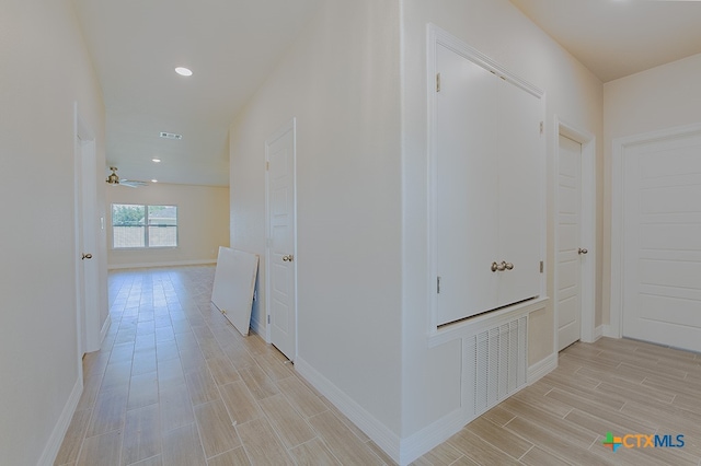 hallway with light hardwood / wood-style floors