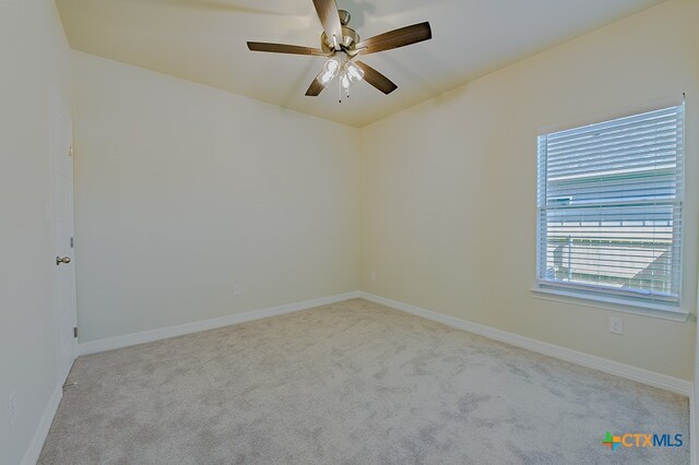 spare room featuring ceiling fan and light colored carpet