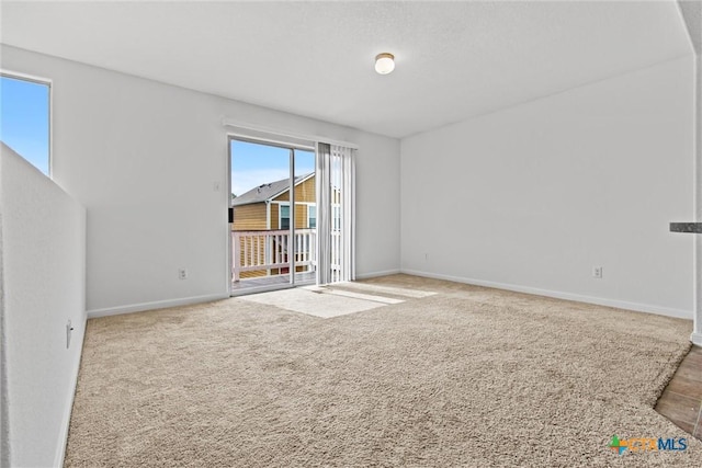 unfurnished room with baseboards