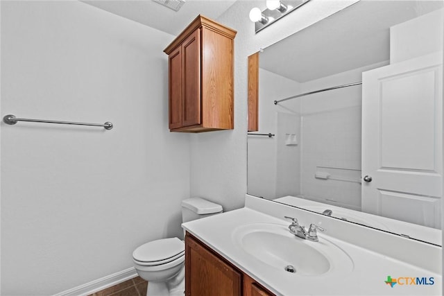 full bathroom with vanity, baseboards, walk in shower, and toilet