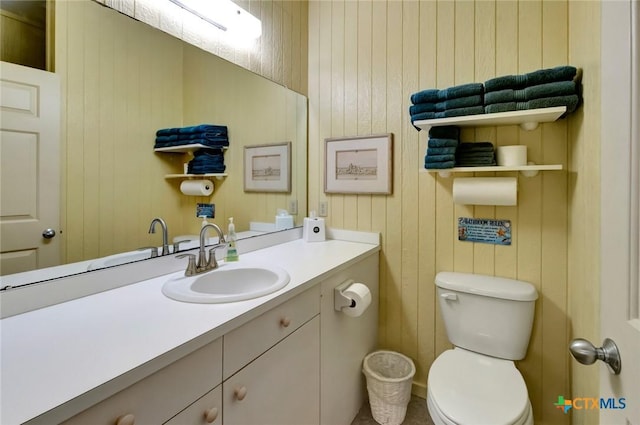 half bathroom featuring toilet and vanity