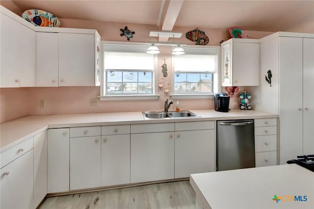 kitchen with beam ceiling, light countertops, a sink, light wood-type flooring, and dishwasher