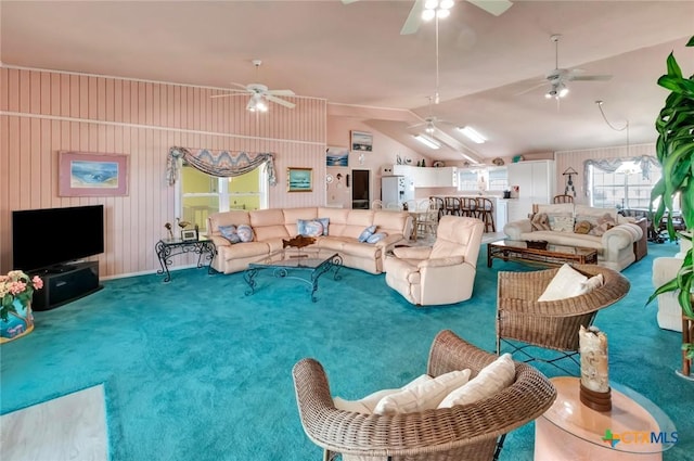 living area with lofted ceiling, carpet, and ceiling fan