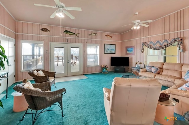 carpeted living area with vaulted ceiling, french doors, a healthy amount of sunlight, and ceiling fan