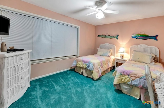 carpeted bedroom with a ceiling fan and baseboards