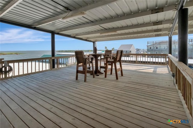 wooden deck featuring a water view