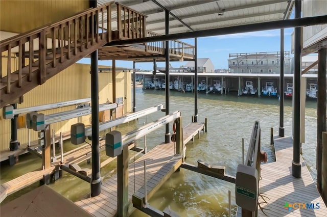 dock area with a water view and boat lift