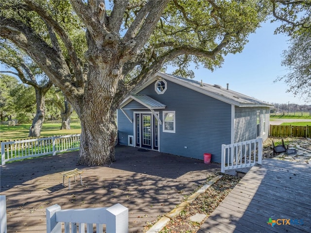 view of front of property with a deck and fence