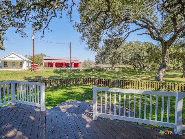 wooden terrace featuring a lawn and fence