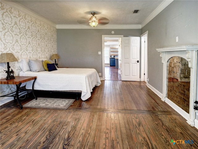 bedroom featuring crown molding, visible vents, baseboards, and dark wood-style flooring