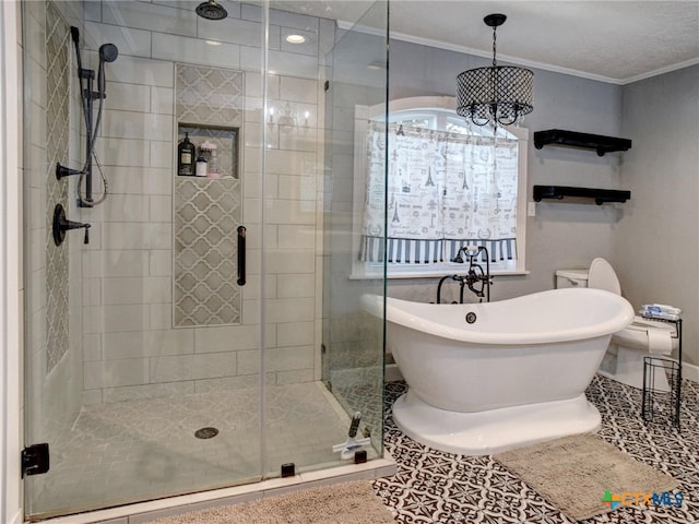 full bath featuring crown molding, a shower stall, a freestanding tub, and tile patterned floors