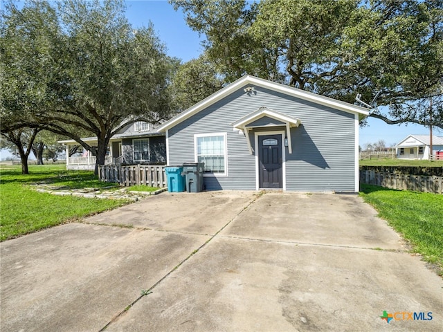 view of front of property with a front yard and fence