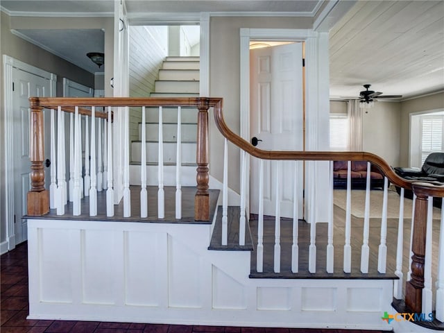 staircase with ceiling fan and crown molding