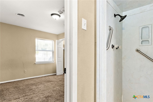 bathroom with baseboards, visible vents, and a shower