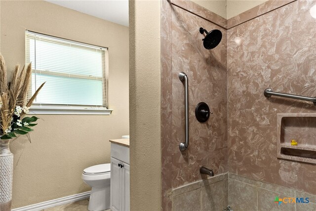 bathroom with baseboards, vanity, toilet, and walk in shower