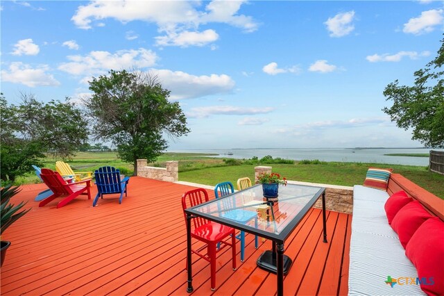 601 Lakewood Dr, Burnet, TX 78611 - deck with a lawn, outdoor dining area, and a water view