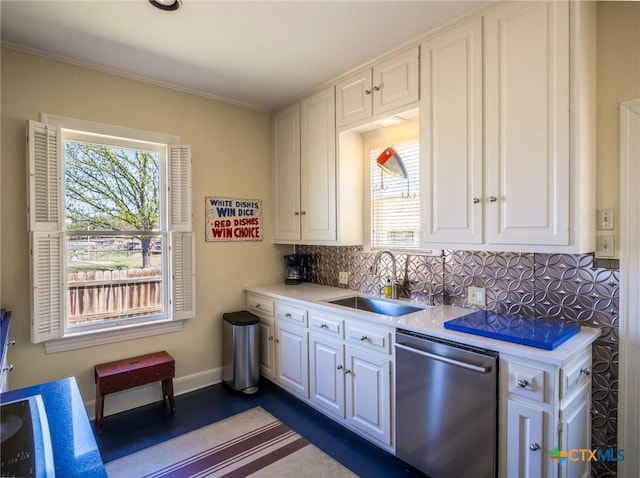 601 Lakewood Dr, Burnet, TX 78611 - kitchen with white cabinets, a sink, dishwasher, light countertops, and tasteful backsplash