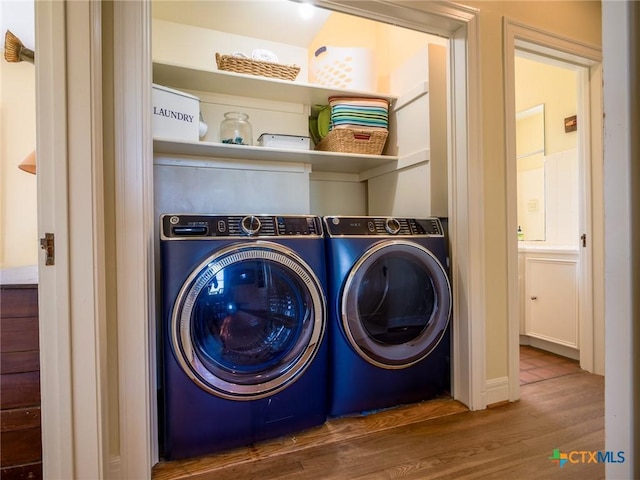 601 Lakewood Dr, Burnet, TX 78611 - washroom with laundry area, washing machine and dryer, and wood finished floors