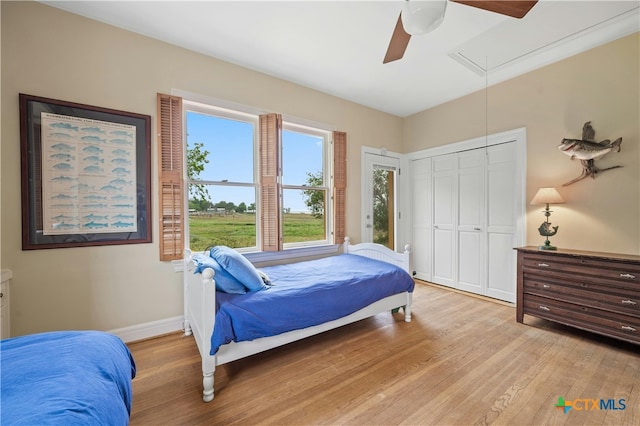601 Lakewood Dr, Burnet, TX 78611 - bedroom with light wood-style floors, baseboards, ceiling fan, and attic access