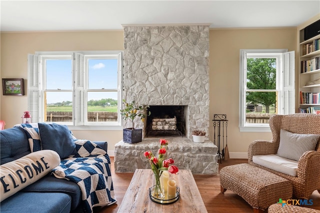601 Lakewood Dr, Burnet, TX 78611 - living area featuring baseboards, wood finished floors, and a fireplace