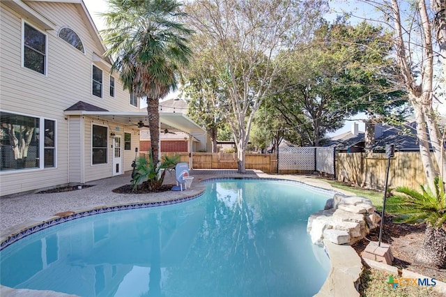 view of swimming pool featuring ceiling fan