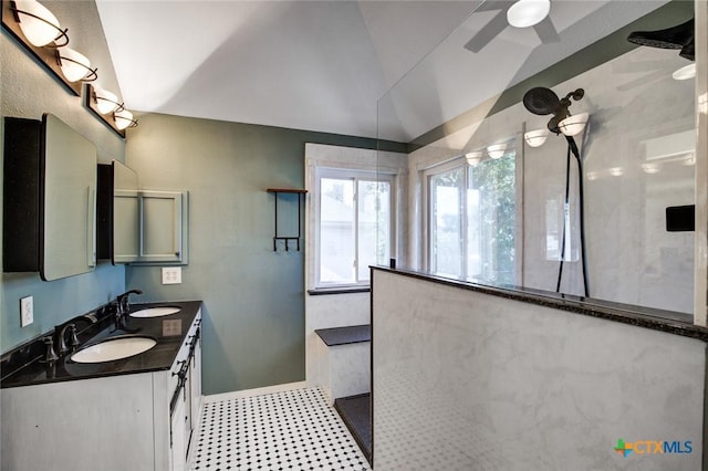 bathroom with a shower, ceiling fan, vanity, and lofted ceiling