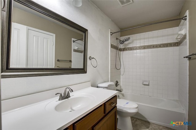 full bathroom with tile patterned flooring, vanity, toilet, and tiled shower / bath combo