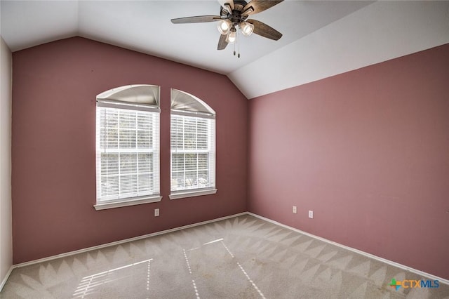 empty room featuring light carpet, ceiling fan, and lofted ceiling