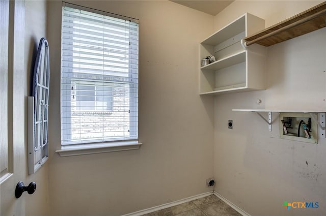 washroom with washer hookup, electric dryer hookup, and light tile patterned flooring