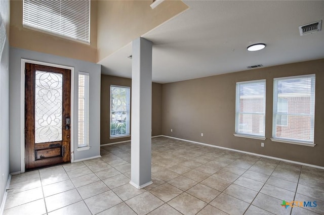 foyer entrance with light tile patterned floors