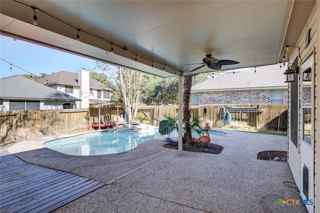 view of pool with a patio area and ceiling fan