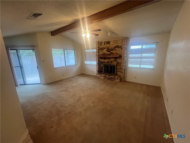 2402 Lago Trl, Killeen, TX 76543 - unfurnished living room with baseboards, ceiling fan, a fireplace, carpet floors, and a textured ceiling
