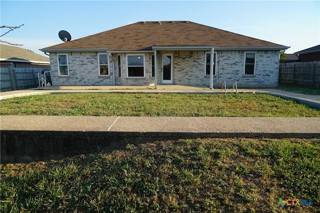 401 James Loop, Killeen, TX 76542 - back of house featuring a fenced backyard, brick siding, and a patio