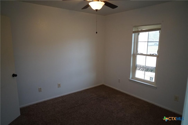 carpeted spare room featuring ceiling fan