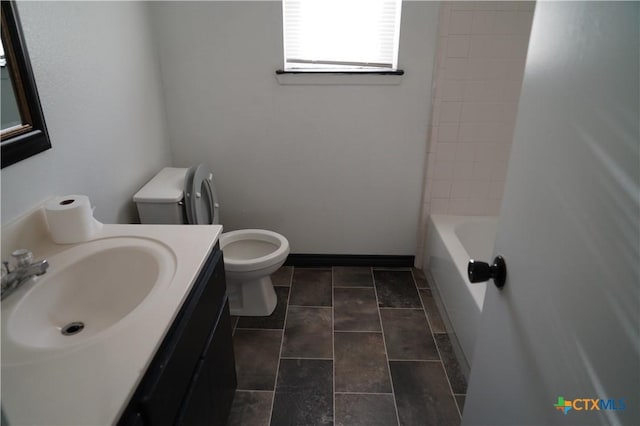 full bathroom with bathtub / shower combination, vanity, and toilet