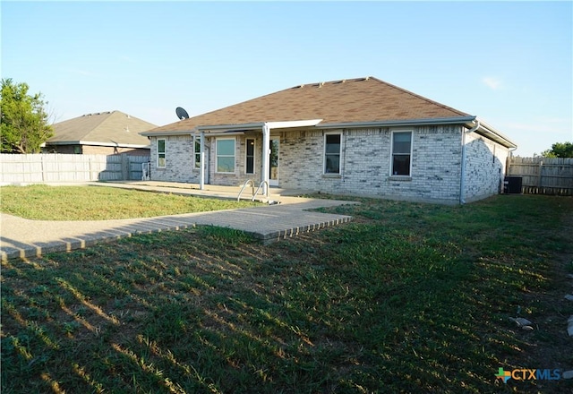 back of property featuring a lawn