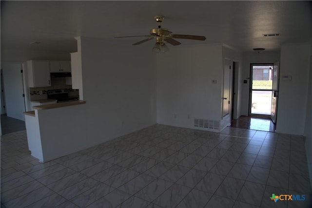 unfurnished living room featuring ceiling fan and light tile patterned floors