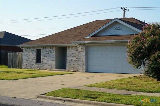 single story home featuring a garage and a front lawn