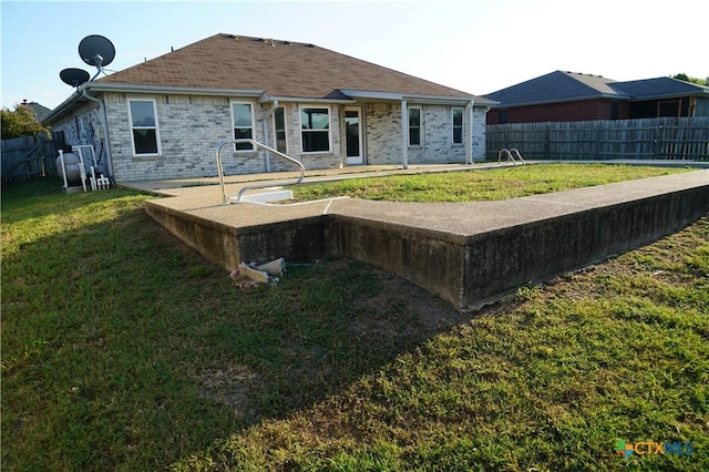 rear view of house featuring a lawn