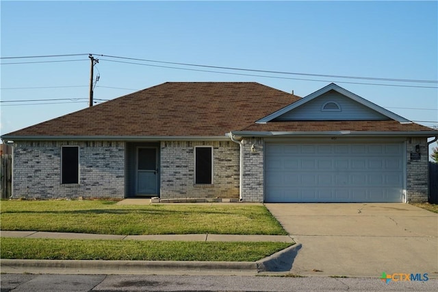 ranch-style house with a garage and a front lawn