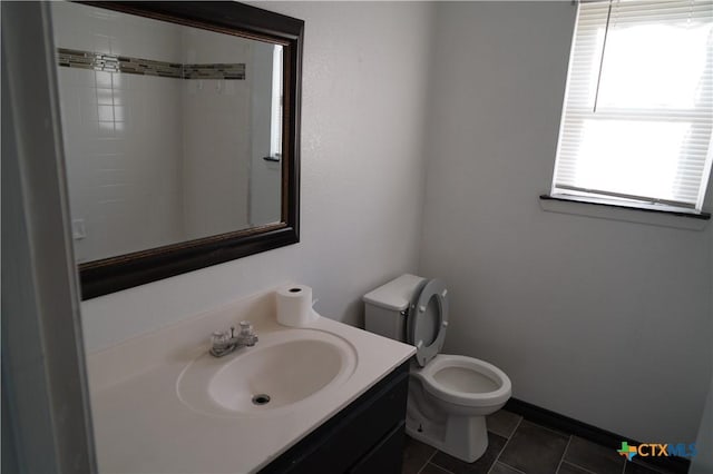 bathroom featuring tile patterned flooring, vanity, and toilet