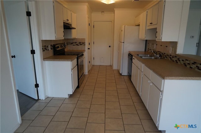 kitchen with white cabinets, tasteful backsplash, range with electric stovetop, and sink