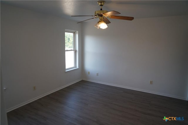 spare room with dark hardwood / wood-style flooring and ceiling fan