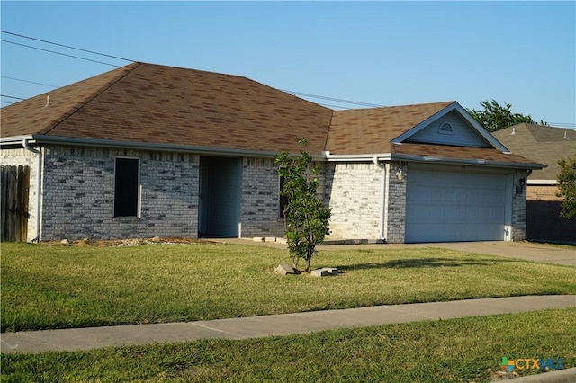 ranch-style house featuring a front lawn and a garage