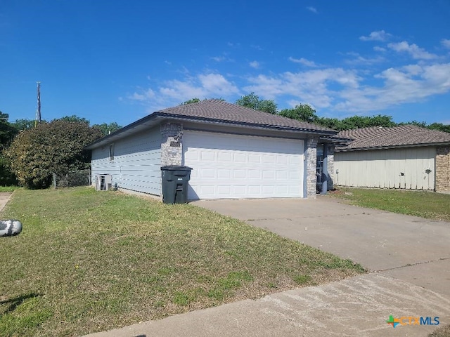 view of property exterior with a lawn and a garage