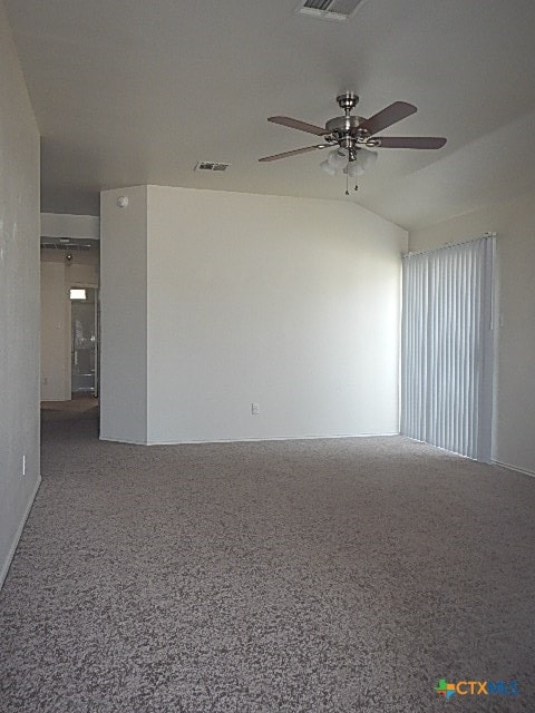 carpeted spare room with ceiling fan