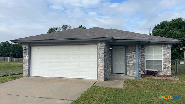 view of front of home featuring a garage and a front lawn