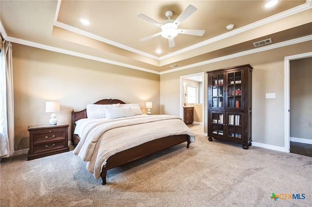 bedroom with a raised ceiling, carpet flooring, crown molding, and baseboards