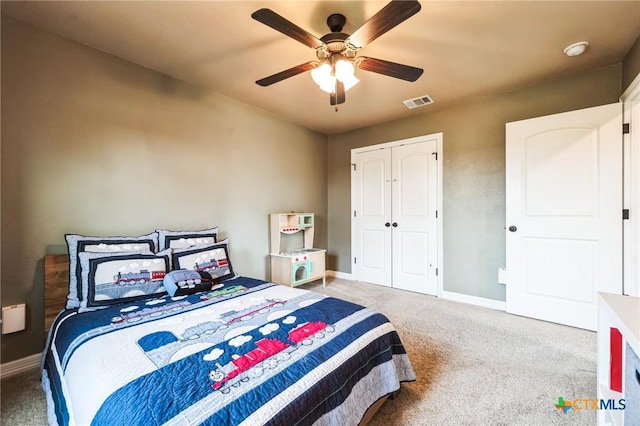 carpeted bedroom featuring visible vents, baseboards, a closet, and a ceiling fan