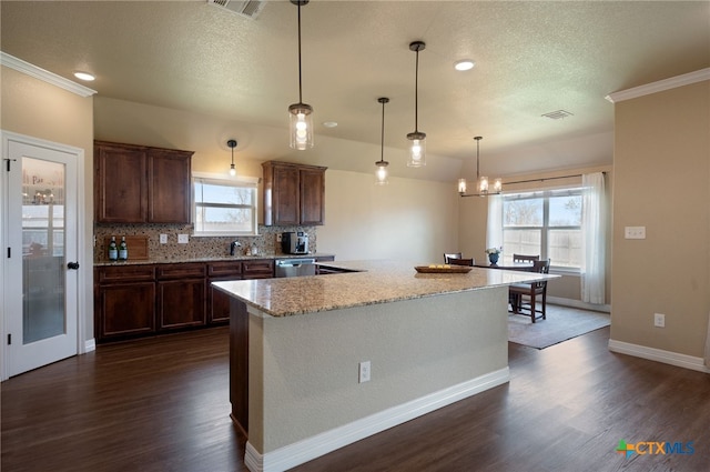 kitchen with visible vents, dark wood-type flooring, tasteful backsplash, a textured ceiling, and dishwasher